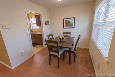 Dining area overlooks deck and has large window.