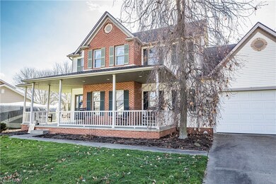 View of front of property featuring covered porch and a garage