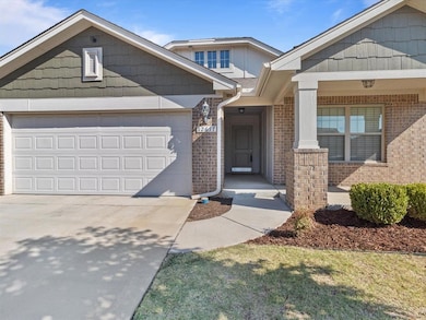 View of front facade featuring a garage and a porch