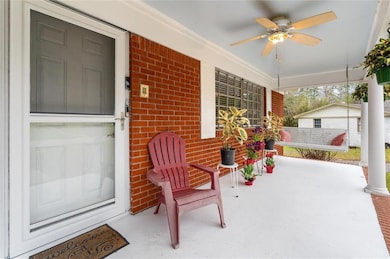 View of patio featuring a ceiling fan and covered 