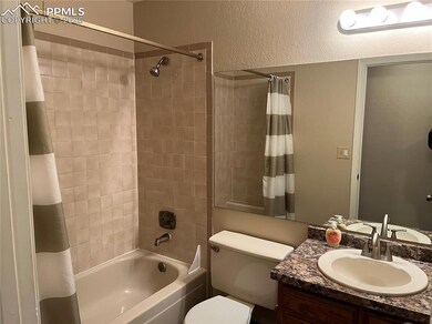 Full bathroom on main level featuring vanity, show