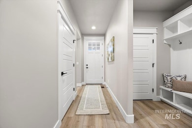 Mudroom featuring light wood-style flooring and recessed lighting
