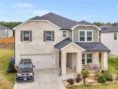 View of front of house featuring a garage and a fr
