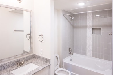 Full bathroom with vanity, toilet, and shower / bathtub combination with curtain