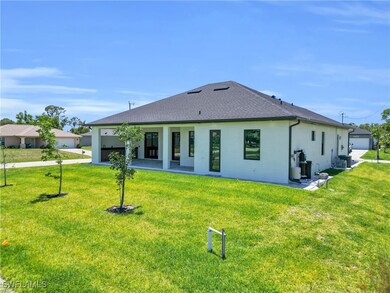 Rear view of property featuring stucco siding, a l