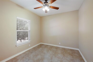 Unfurnished room featuring a ceiling fan and light tile patterned floors