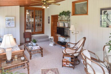 Spacious sun room with vaulted, wood plank ceiling
