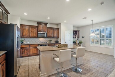 Kitchen with decorative backsplash, an island with
