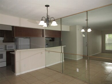 Mirrored dining room is open to kitchen.