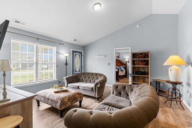 Living area featuring a textured ceiling, wood fin