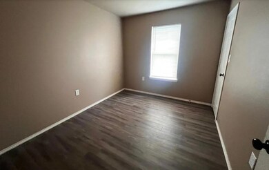 Unfurnished room featuring dark wood-style floors 