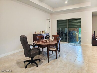 Tiled dining space with a tray ceiling