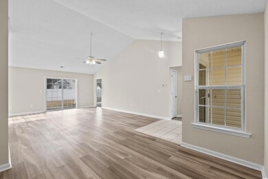 Unfurnished living room featuring ceiling fan, lig