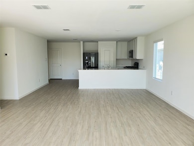 Kitchen with black appliances, baseboards, a sink,