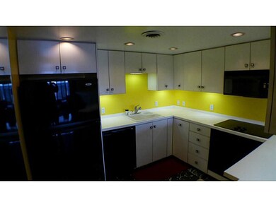 Kitchen. Sleeeek black appliances.  Recessed light