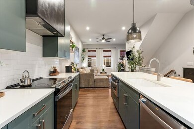 Kitchen featuring dark wood finished floors, stain