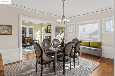Dining room featuring wood finished floors, a chandelier, and ornamental molding