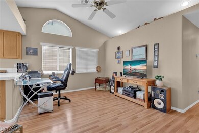 Office area featuring a ceiling fan, light wood-ty