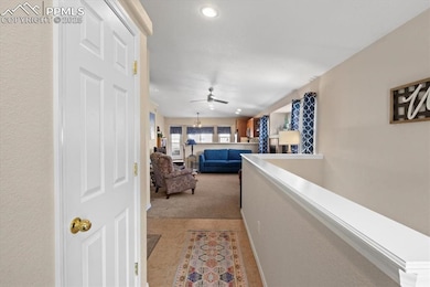 Corridor featuring light colored carpet and recess