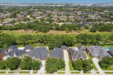 An aerial view of the home, which backs to a green