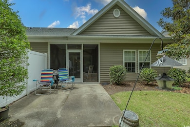 Back of house featuring a patio area, a sunroom, and a shingled roof