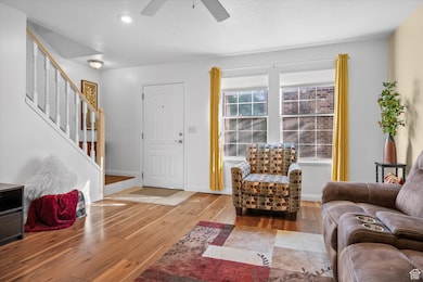 Living room featuring hardwood / wood-style flooring, stairway, and recessed lighting