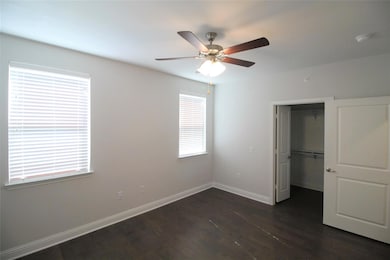 Unfurnished bedroom featuring a walk in closet, a 