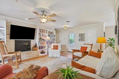 Living area featuring wood finished floors, a bric