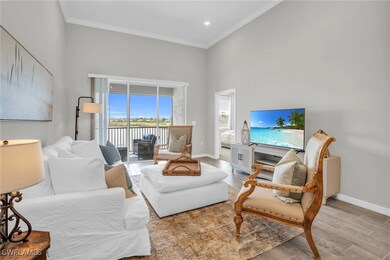 Living area with crown molding, wood finished floo