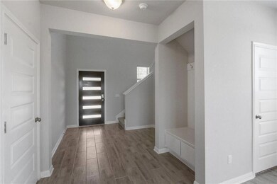 Foyer entrance with wood finished floors, stairs,