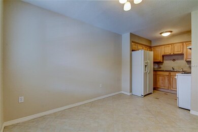 Dining and kitchen have clean tile floors.
