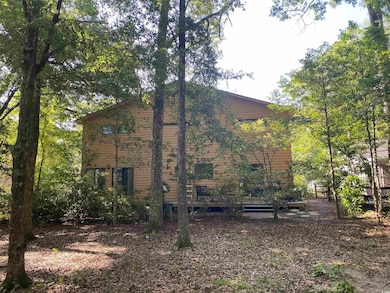 View of side of home with a wooden deck