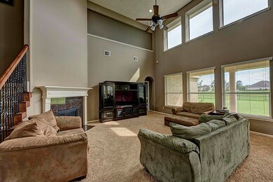Family Room with 6 large windows looking out to the lake.  Eighteen foot ceiling height open to the upstairs.