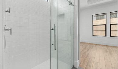 Primary bath with glass shower enclosure