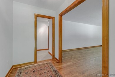 Hallway featuring baseboards and wood finished flo