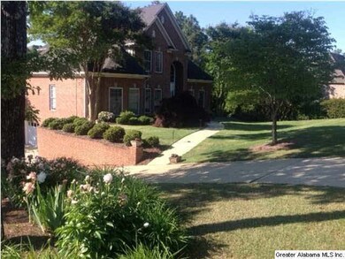 Many beautiful flowers and shrubs surround the hom