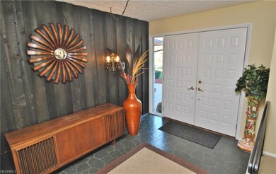 Double doors open to a welcoming foyer overlooking