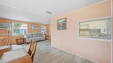 Dining room with light wood finished floors and wood walls