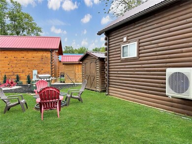 View of yard with shed and firepit