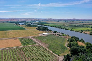 Aerial view of sparsely populated area featuring abundant farmland and a nearby body of water
