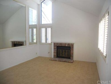 Living Room with Fireplace and Plantation Shutters