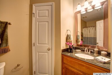 Full bath with granite-top vanity