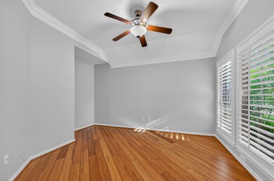 Study/flex bedroom with ceiling fan, crown molding