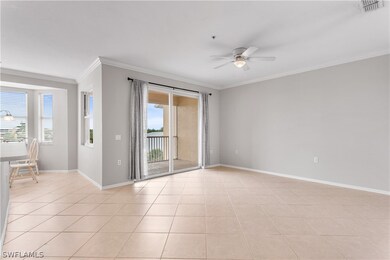 Tiled empty room featuring ceiling fan and crown m
