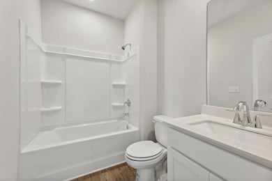 Bathroom featuring toilet, wood finished floors, v