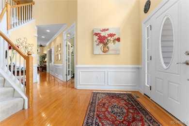 Foyer with light wood-type flooring, stairway, cro