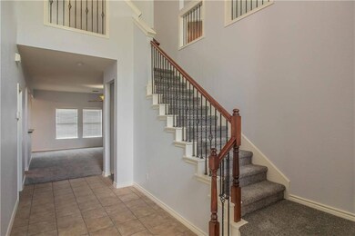 Beautiful entry with iron rail accents on stairway