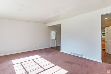 Unfurnished room featuring carpet flooring and baseboards