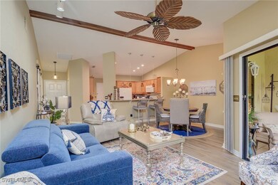 Living area with lofted ceiling, a ceiling fan, li