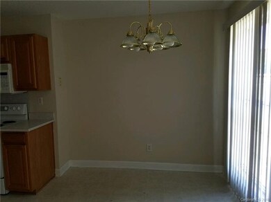 Dining area has lovely chandelier and full length 